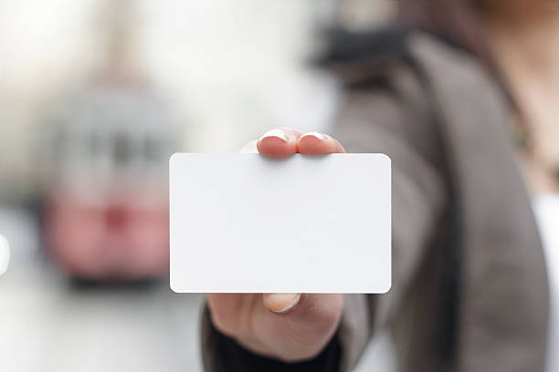 Young women holding a blank card in hands stock photo