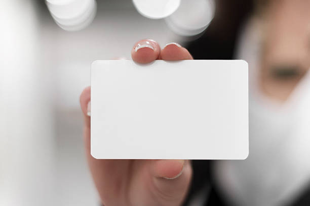 Young women holding a blank card in hands stock photo