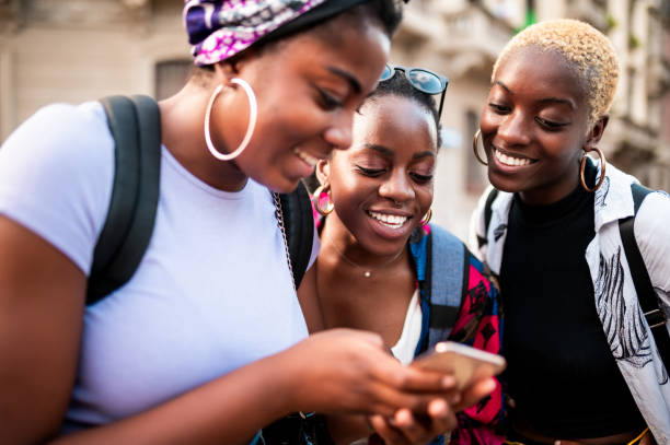 Young women looking at mobile phone stock photo
