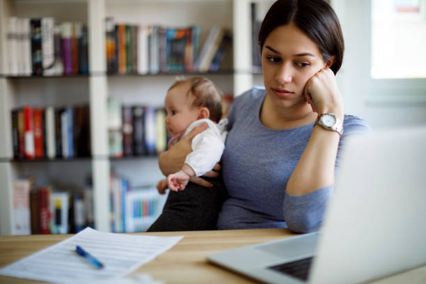 Young worried mother working from home Young worried mother working from home unemployment photos stock pictures, royalty-free photos & images