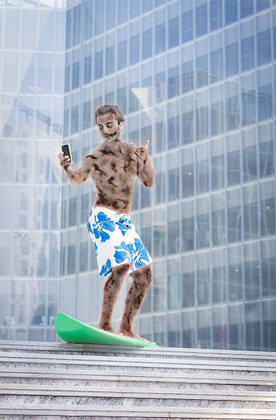 Young zombie (businessman) surf with smart phone outside office - Needs vacations ! Escape from the work