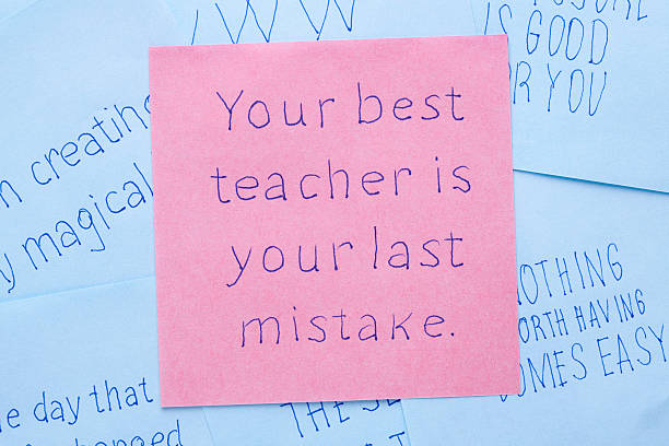 Your best teacher is your last mistake written on note stock photo