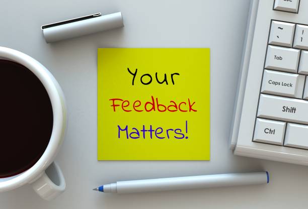Your Feedback Matters, message on note paper, computer and coffee on table stock photo
