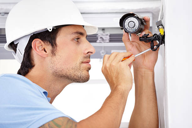 Your home security is in capable hands Shot of a handsome young man    installing a security camerahttp://195.154.178.81/DATA/shoots/ic_781742.jpg burglar alarm stock pictures, royalty-free photos & images