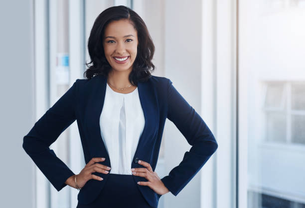 You're worth more than you believe Portrait of a confident young businesswoman standing in an office hand on hip stock pictures, royalty-free photos & images