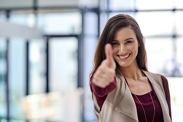 You've got my approval! Cropped shot of an attractive young businesswoman in the office business thumbs up stock pictures, royalty-free photos & images