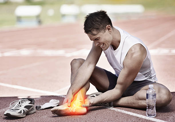 You've got to break down before you can build up Shot of a young athlete holding his leg in pain ankle stock pictures, royalty-free photos & images