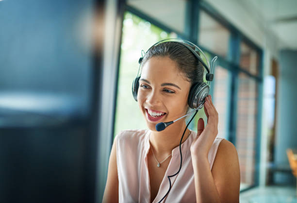 You’ve reached our support line Shot of a young woman working in a call center call center photos stock pictures, royalty-free photos & images