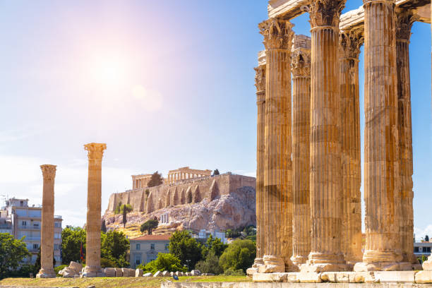 Zeus temple overlooking Acropolis, Athens, Greece Zeus temple overlooking Acropolis, Athens, Greece. These are famous landmarks of Athens. Sunny view of Ancient Greek ruins, great columns of classical building in Athens city center. Travel concept. ancient history stock pictures, royalty-free photos & images