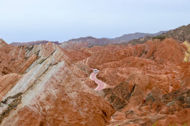 Zhangye Danxia National Geopark Amazing scenery of Rainbow mountain and blue sky background in sunset. Zhangye Danxia National Geopark, Gansu, China. Colorful landscape, rainbow hills, unusual colored rocks, sandstone erosion danxia landform stock pictures, royalty-free photos & images