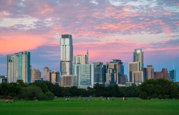 Zilker Park Sunset Austin Texas green grass landscape and perfect glowing Cityscape stock photo