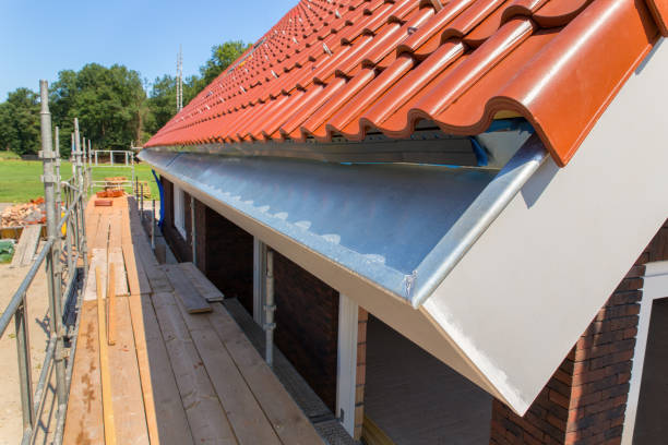 Zinc rain gutter with roof tiles and scaffolding stock photo