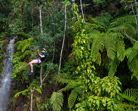 Zip line in Costa Rica against green foliage