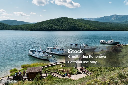 Zmeyevaya bay, Chivyrkuisky bay of Baikal, Russia. Boats bringing tourists to visit thermal spring