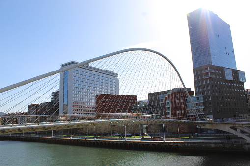 Bilbao, Spain – February 26, 2022: Zubizuri Bridge, an example of modern architecture in Bilbao downtown.