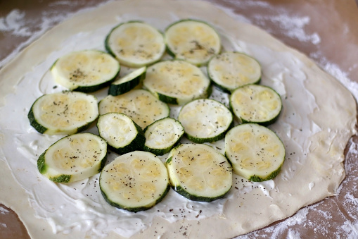Preparing zucchini and courgette galette with herbs and spices. Selective focus.