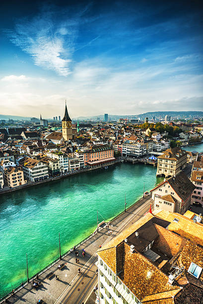 Zurich Cityscape, Switzerland Aerial view of Zurich, Switzerland. Taken from a church tower overlooking the Limmat River. Beautiful blue sky with dramatic cloudscape over the city. Visible are many traditional Swiss houses, bridges and churches. zurich stock pictures, royalty-free photos & images