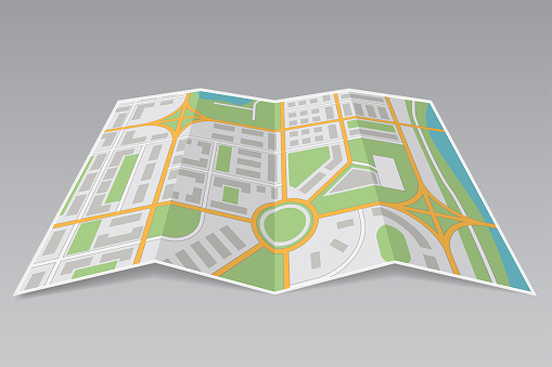 Abstract city map. Paper partially folded on gray background