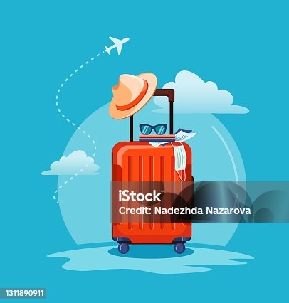 istock Airplane flying above tourists luggage: suitcase, passport, tickets, medical mask and sunglasses. 1311890911
