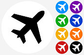Airplane Icon on Flat Color Circle Buttons. This 100% royalty free vector illustration features the main icon pictured in black inside a white circle. The alternative color options in blue, green, yellow, red, purple, indigo, orange and black are on the right of the icon and are arranged in two vertical columns.