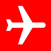 Airplane.The main icon is placed on a flat red background. It takes up the center portion of the composition and is the main focus of this vector illustration. The icon is simple and the background further emphasizes the icon shape and makes it stand out. The illustration is a 100% royalty free vector.