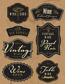 Vector illustration of a set of assorted retro wine bottle labels. Top left labels read: Wine Cork, Wine Cabernet Sauvignon, Oak Barrell, Vintage Wine Pinot Noir, Vintage Wine, Wine Estate and Table Wine Award Winning. Download includes Illustrator 10 eps with transparencies, high resolution jpg and png file.