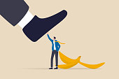 istock Avoid business mistake or failure, protect from accident or pitfall, insurance or warning in business risk and support in crisis concept, confidence businessman hero protect from slippery banana peel. 1328312779