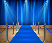 istock Awards show background with blue curtains and blue carpet between rope barriers 1316621312