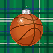 Vector illustration of a shiny basketball christmas ornament with shadow on a green plaid background.