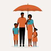 istock Black Family Standing Under An Umbrella. 1346644806