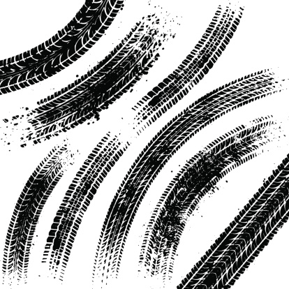 Curved black tyre tracks with grunge splatters.