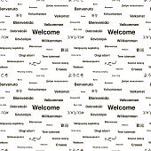 Black welcome phrases in different languages of the world on white, seamless pattern