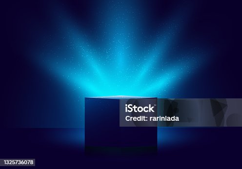 istock 3D blue mystery box with Illuminated lighting glitter on dark background 1325736078