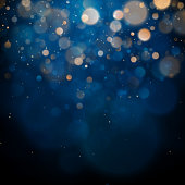 Blurred bokeh light on dark blue background. Christmas and New Year holidays template. Abstract glitter defocused blinking stars and sparks. EPS 10 vector file