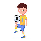 Boy football player kicks the ball isolated on a white background. Vector illustration of a little child soccer. Cartoon cute character boy football player stuffs the ball on his knee leg.