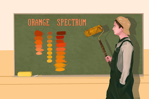 Boy in an art class learning the spectrum of orange color