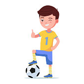 Boy soccer player in sportswear standing with his foot on a ball. Young child football player holds thumb up. Vector illustration isolated on white, flat style.
