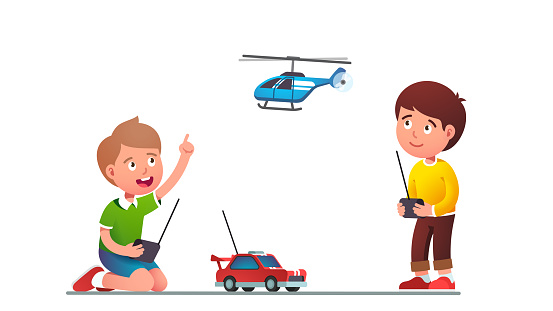 Boys kids playing with radio-controlled toy car and helicopter