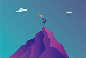 istock Business man climbed to the top of the mountain and completed the goal 1293480770