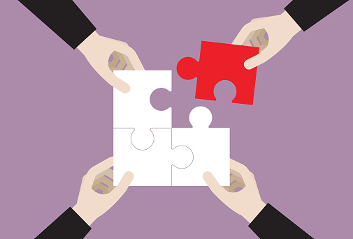 Business people holding a jigsaw puzzle