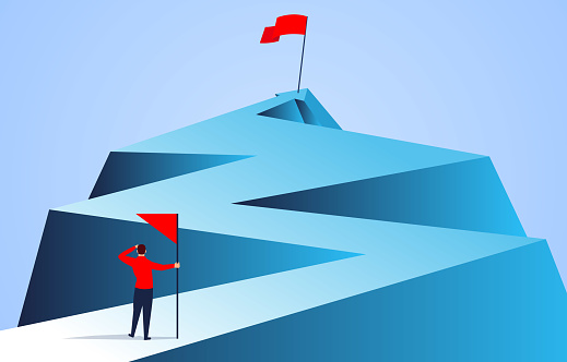 Businessman holding a flag looking at the flag farther from the top of the arrow