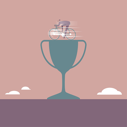 A businessman riding a bicycle on a trophy.