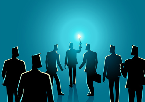 Businessman with torch leading another businessmen behind him