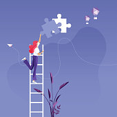 Businesswoman on ladder installing the final piece of puzzle-Business success concept