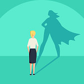 Businesswoman with superhero shadow vector concept. Business symbol of emancipation ambition and success motivation. Leadership or courage and challenge. Eps10 vector illustration.