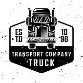 istock Cargo transport company vector monochrome emblem, badge, label or logo with truck isolated on white background with removable textures 1321160282