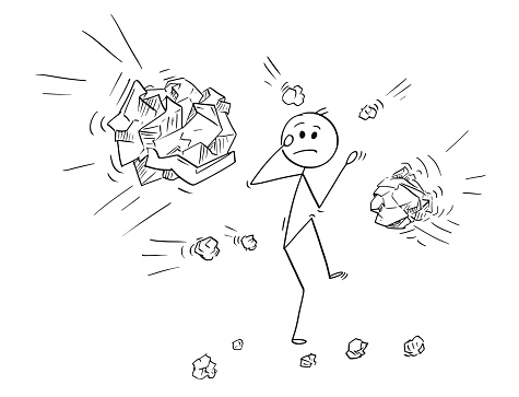 Cartoon of Businessman Hit or Stoned by Crumpled Paper Balls