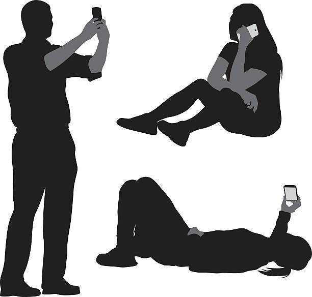 Cellphone Talking And Selfies A vector silhouette illustration of three young adults on their cell phones. A young man takes a photo graph, a young woman sits on the ground and talks, while another young woman lays down and reads hers. selfie silhouettes stock illustrations