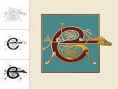 Set with four variations of the letter E in the shape of a donkey. Three versions are in black and white and one in color and gold within a square frame. This celtic initials are based on animal heads and shapes combined with celtic knot designs (endless knots). Similar illustrations are known from the various illuminations in medieval, celtic books such as the "book of kells" and the "Lindisfarne gospels".