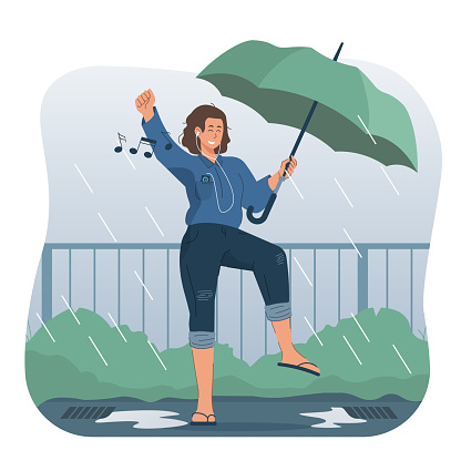 Cheerful girl listening to music while dancing in the rain